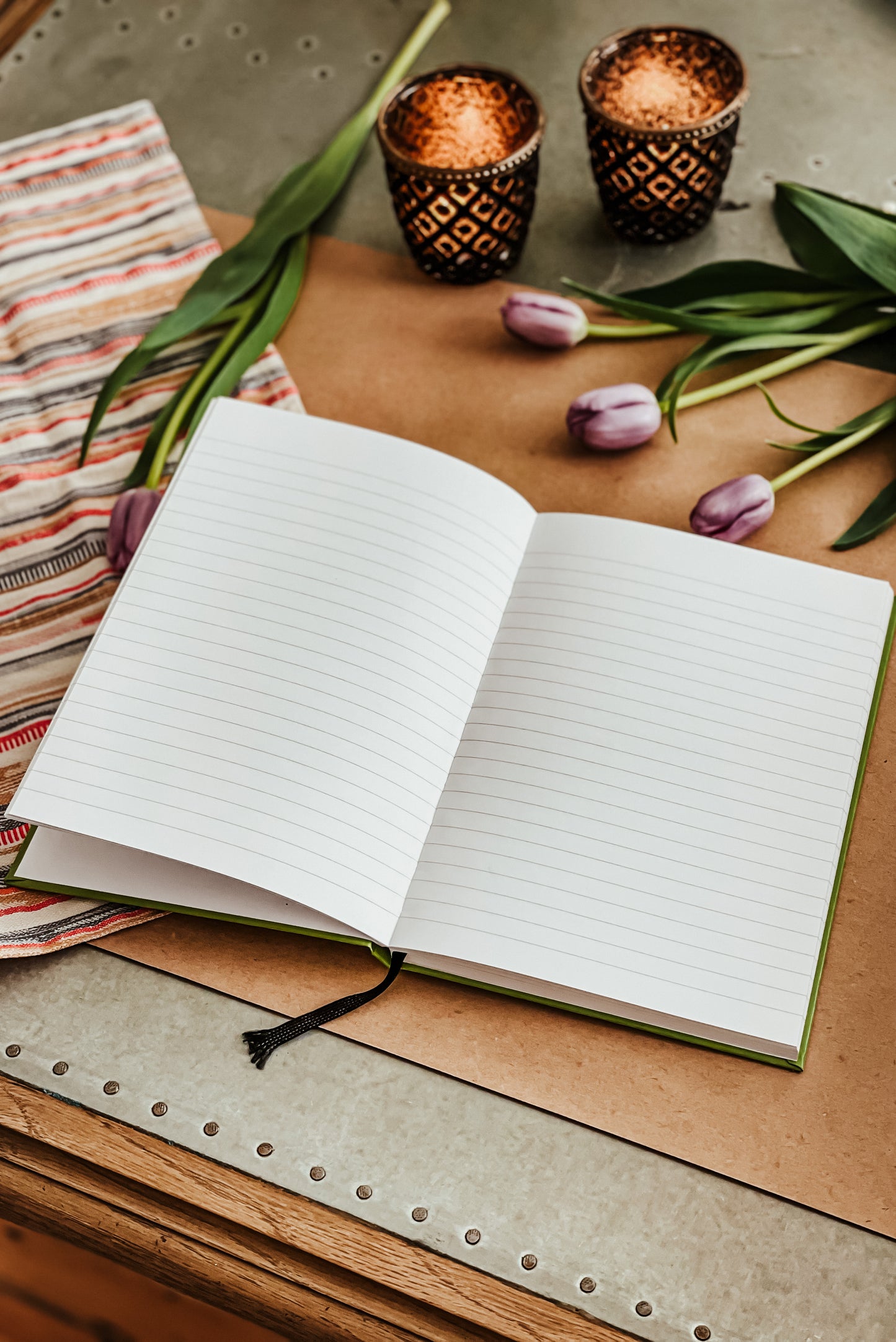 A brightly coloured green A5 hardback notebook with 160 ruled white pages on 80gsm paper. 