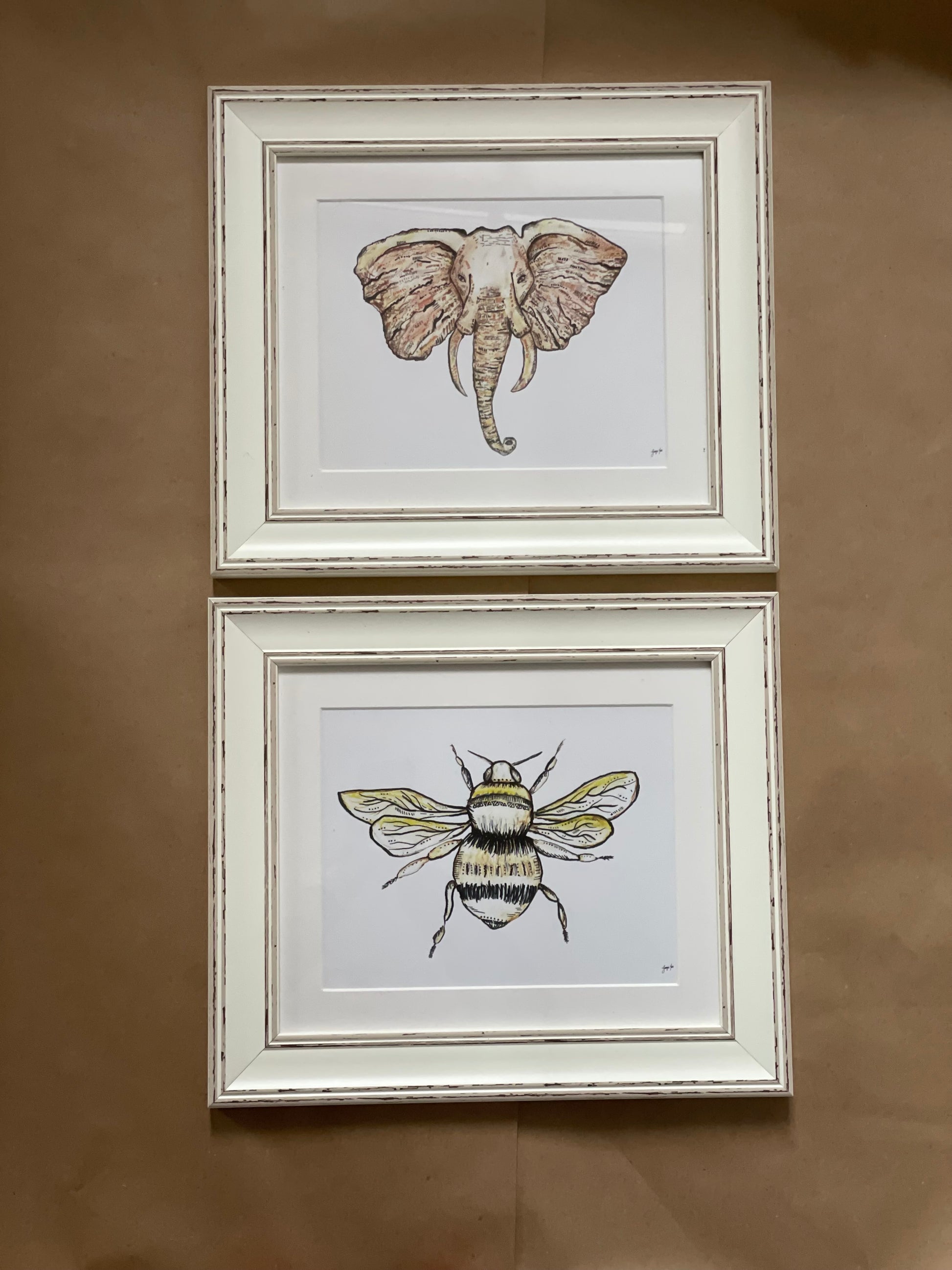 A neutral framed bee and elephant print pair. 