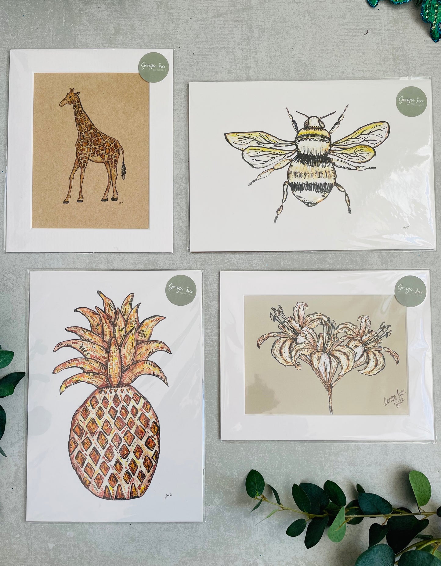 Set of four neutral prints with giraffe, pineapple, lily and bee illustration