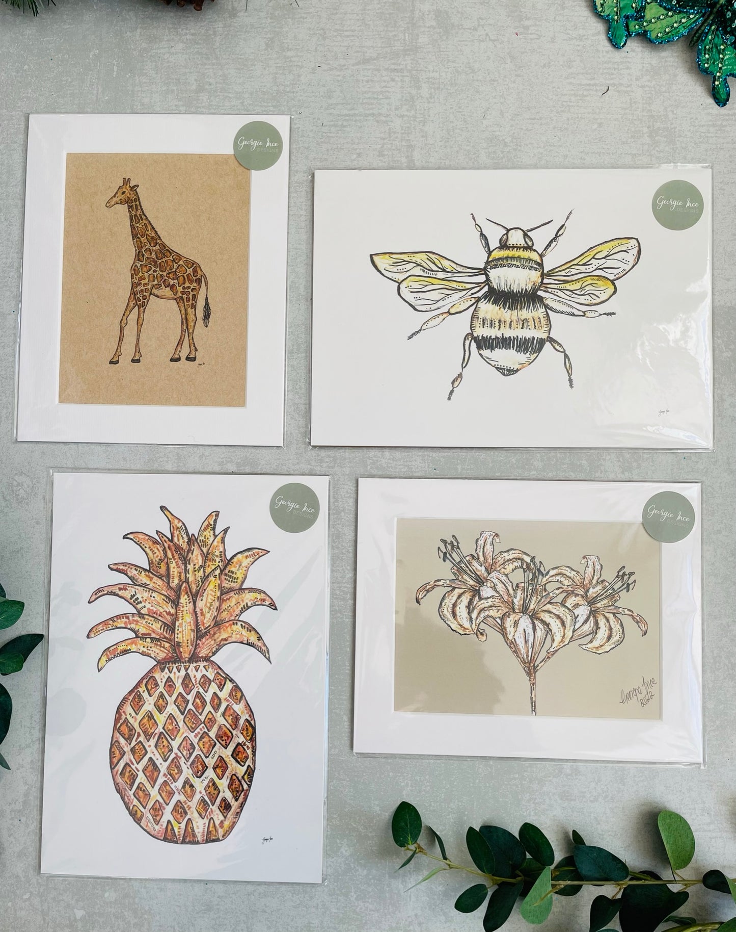 Set of four neutral prints with giraffe, pineapple, lily and bee illustration