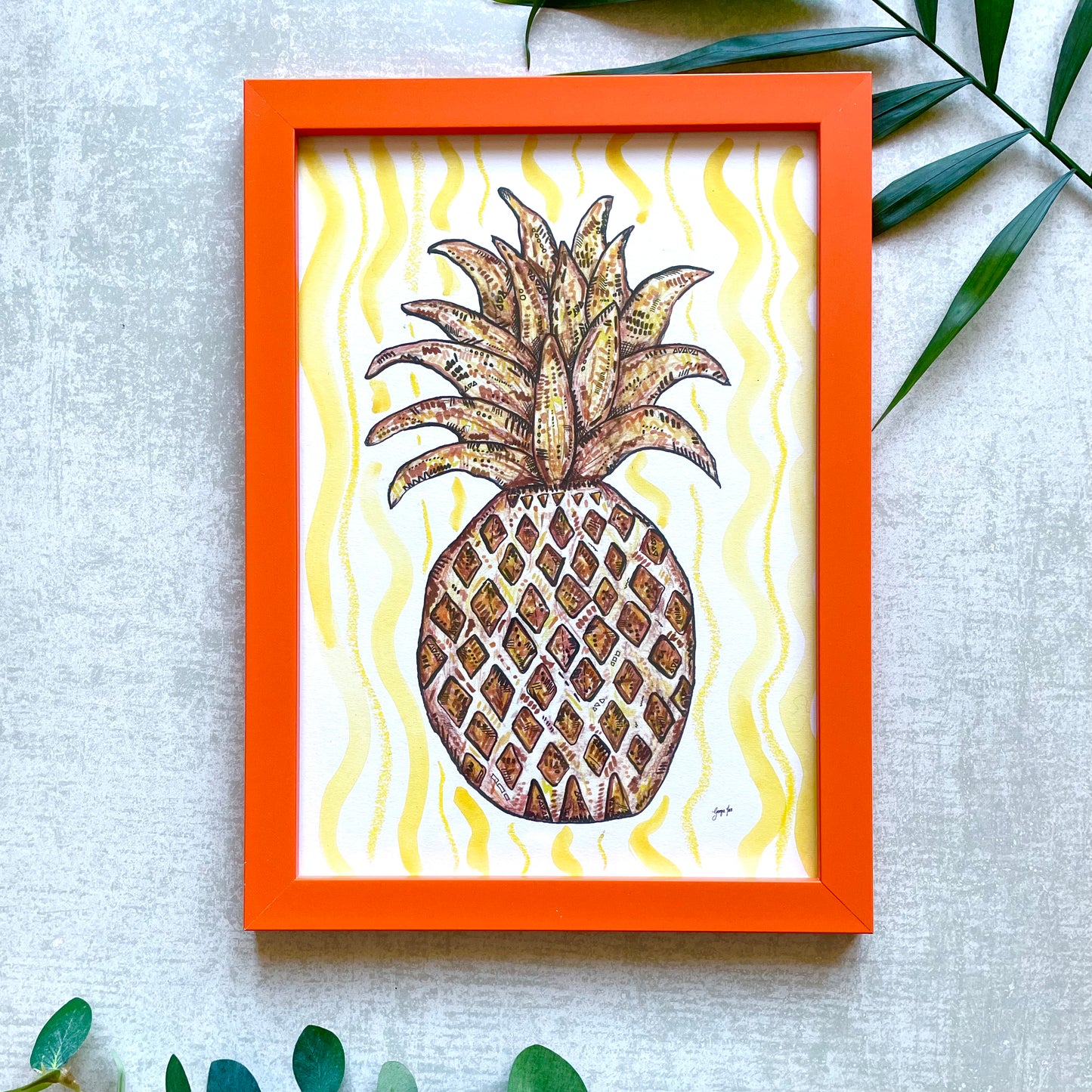 Framed pineapple print with orange frame and yellow watercolour background