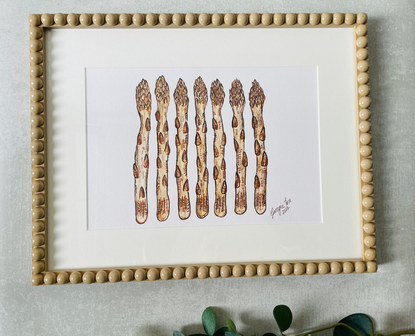 A new framed asparagus in a beige bobbin frame