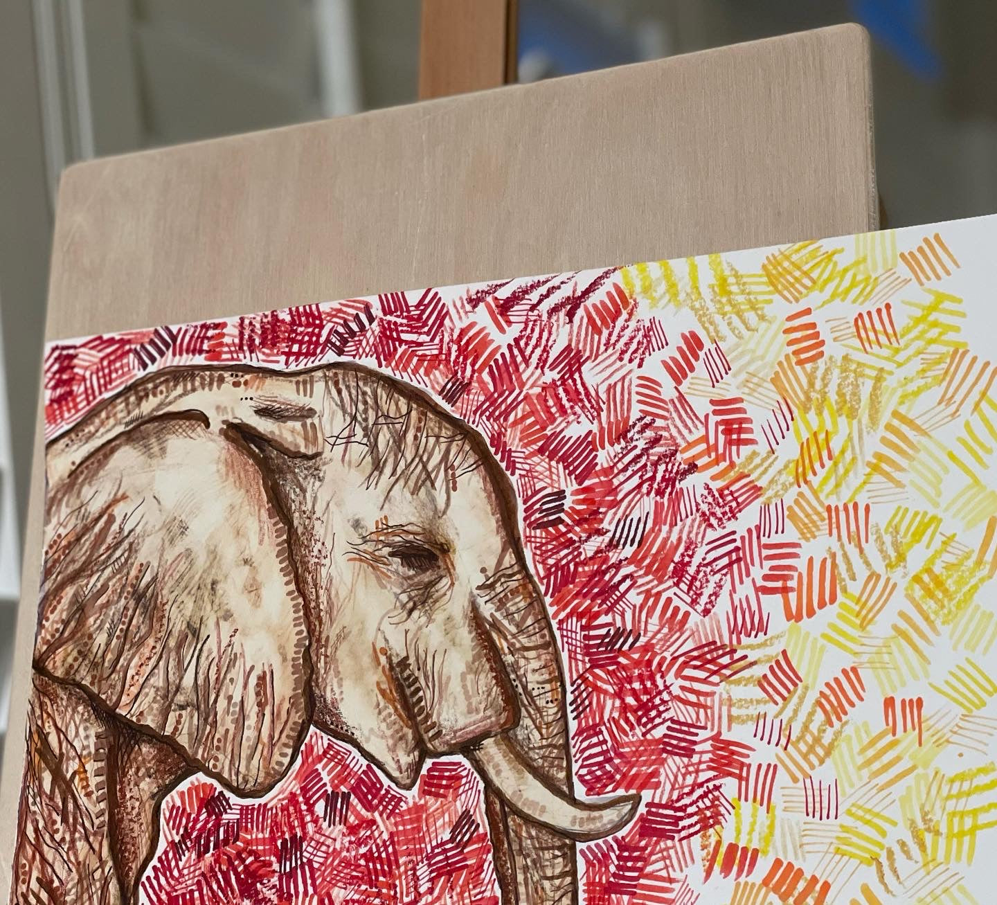 An original elephant ink and bleach drawing with a red, yellow and orange background.