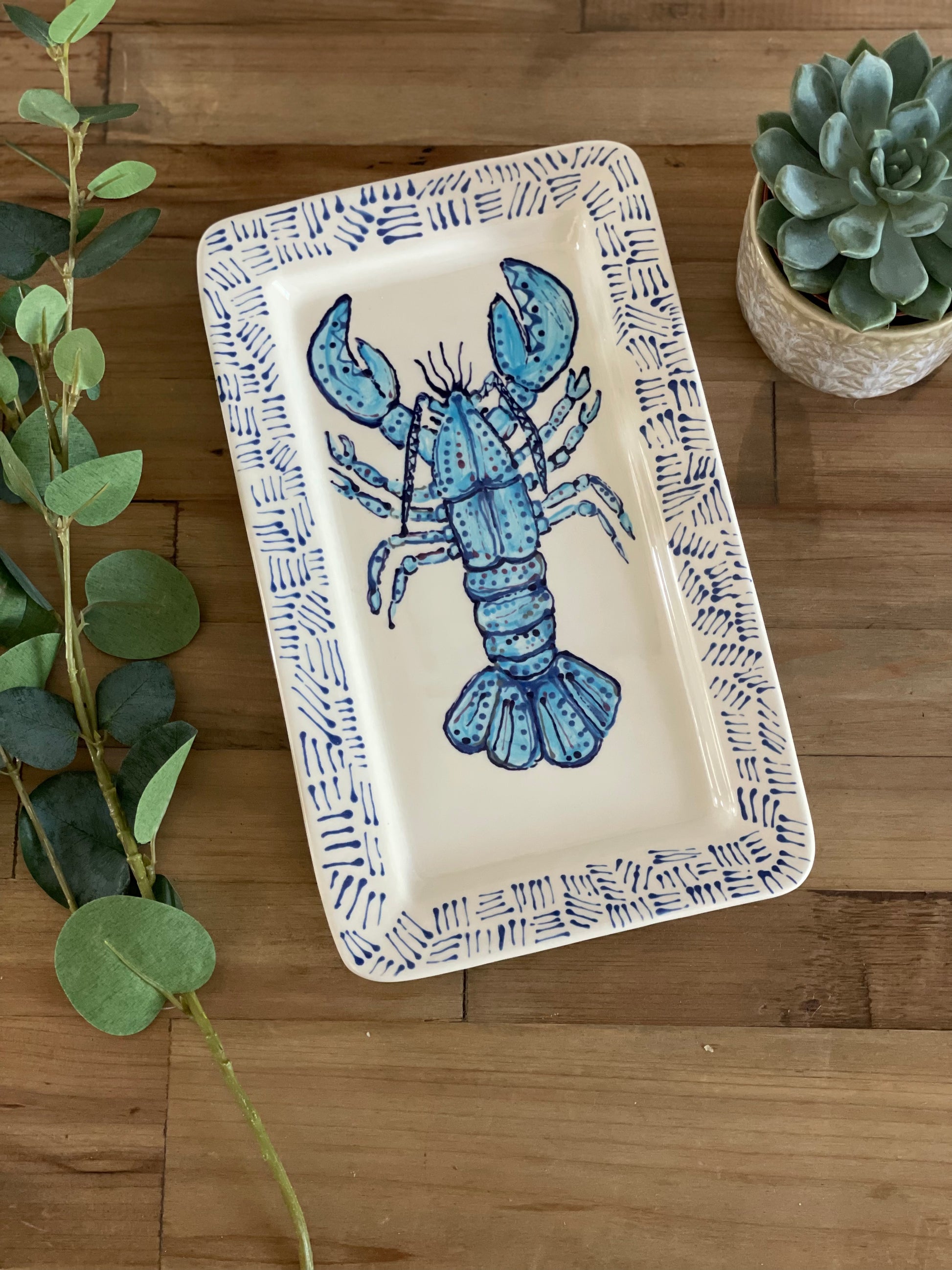 A hand painted blue lobster platter made in the UK. Perfect for outdoor dining this summer!